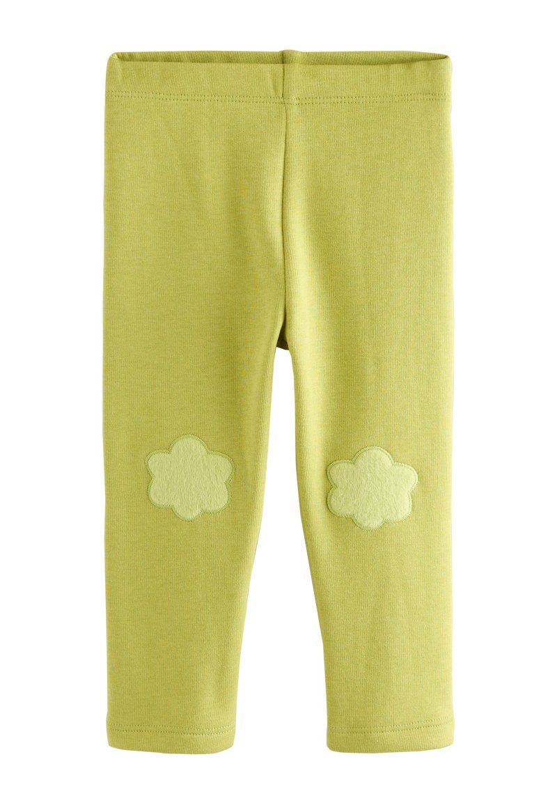 Grüne Baumwoll-Leggings mit elastischem Bund, versehen mit zwei strukturierten, blumenförmigen Applikationen im Kniebereich. Glatte Oberfläche.