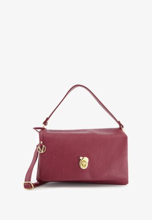 Sac à main en cuir bordeaux d'une forme rectangulaire structurée, doté d'une fermeture en métal doré et d'une bandoulière amovible.