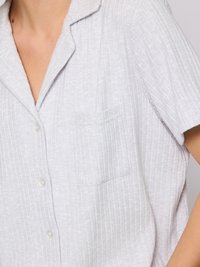 Light gray short-sleeve shirt with a collar, featuring a textured vertical stripe pattern and a single chest pocket. White buttons complete the design.