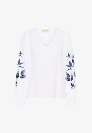 Fehér hosszú ujjú blúz V-nyakú kivitelben, kék és fekete hímzett madarakkal és levelekkel mindkét ujjon.
