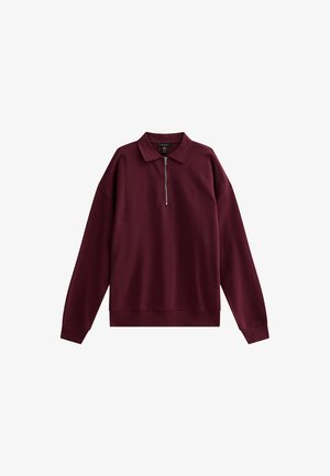 Sweatshirt zippé bordeaux avec un col polo, manches longues, coupe décontractée et poignets et ourlet côtelés. Tissu lisse de couleur unie.