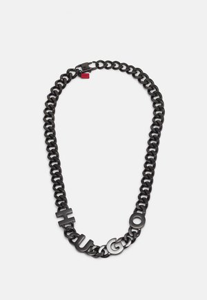Black metal chain necklace with large links and letters spelling "HUGO" on front, featuring a red tag near the clasp.