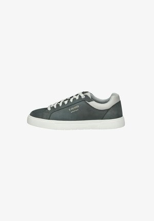 Dark gray suede sneaker with white rubber sole, round toe, and lace-up design. Features subtle branding and contrasting accents at the heel.