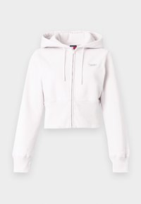 Úzky svetloružový mikinový top z mäkkej látky, s predným zipsom, kapucňou na sťahovanie a rebrovanými manžetami. Jemné logo na hrudi.