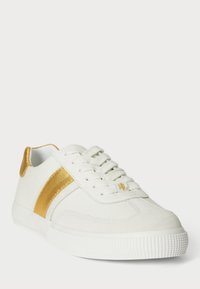 Λευκό sneakers κατασκευασμένα από σουέτ και καμβά, με χρυσή δερμάτινη λωρίδα και χρυσές λεπτομέρειες, καθώς και υφή στη σόλα από καουτσούκ και σχέδιο με κορδόνια.