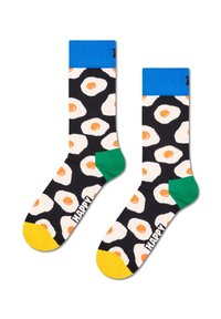 Czarne skarpetki z wzorem smażonych jajek, z niebieskim mankietem, zielonym piętą i żółtym palcem. Materiał wydaje się być mieszanką bawełny.