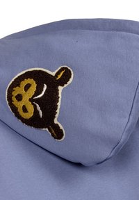 Blue hoodie with a soft texture featuring an embroidered bear patch in dark brown and gold, showcasing rounded ears and facial features.