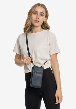 Navy blue textured crossbody bag with gold hardware, zipper closure, and adjustable strap. Rectangular shape with front pocket detail.