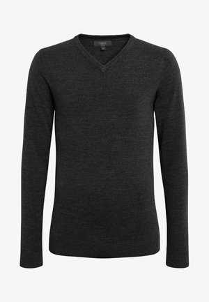 Mørkegrå V-hals trøje lavet af blødt stof, med lange ærmer og en tætsiddende pasform. Ingen mønstre eller hardware detaljer synlige.