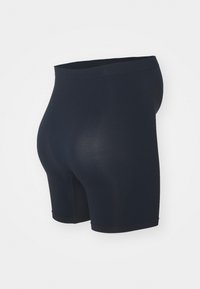 Námořnické modré elastické šortky s hladkým povrchem, střední délky a elastickým pasem, navržené pro pohodlí a flexibilitu.