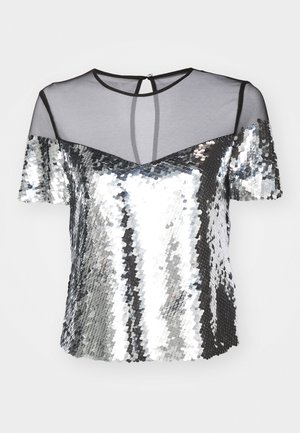 Pailletetop med overdel i sort mesh, korte ærmer og V-formet udskæring. Har en nøglehulsryg og reflekterende sølvtekstur.