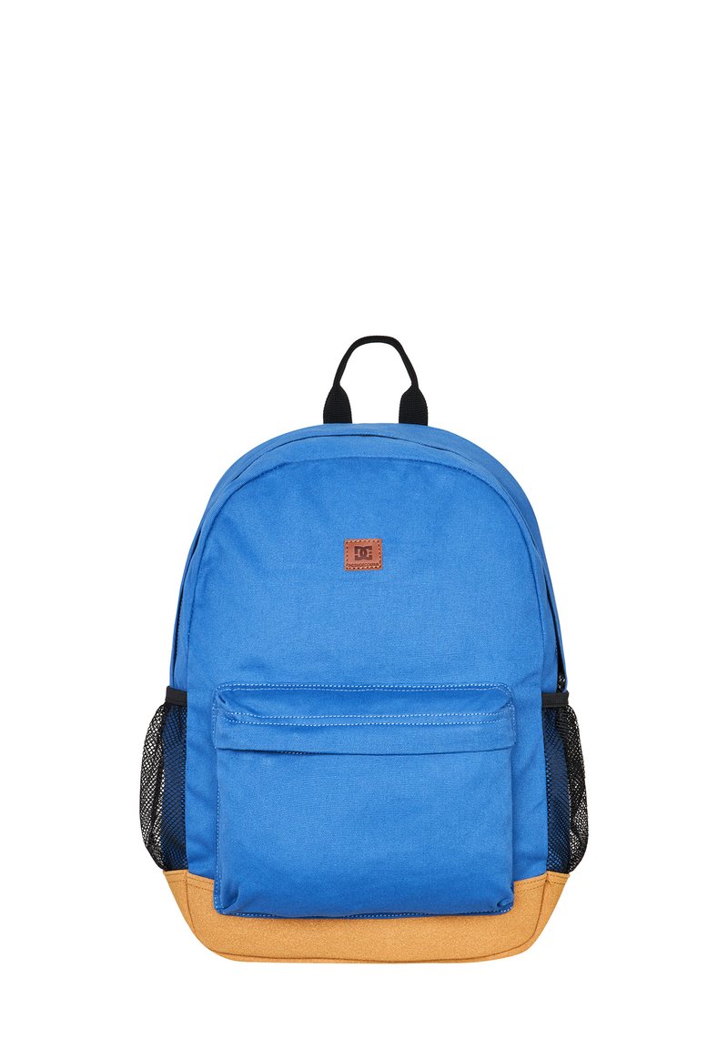 Blauer Stoff-Rucksack mit einem braunen Logo-Patch, frontalem Fach und gelbem Boden. Verfügt über schwarze Netzseitentaschen und zwei obere Tragegriffe.