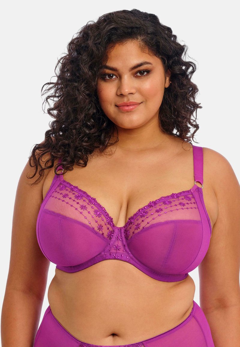 Sujetador morado con bordado floral, copas de malla transparente, tirantes ajustables y un diseño estructurado. Textura de tela suave con detalles elaborados.