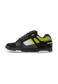 Black and gray sneaker with neon green accents; features a mix of materials, including mesh and leather, with a white rubber sole and branding.
