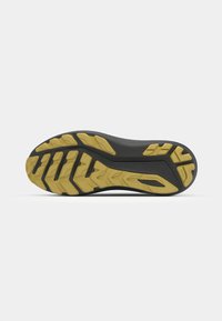 Black sole with textured rubber for grip, featuring yellow accents and a zigzag tread pattern for traction. Curved shape enhances flexibility.