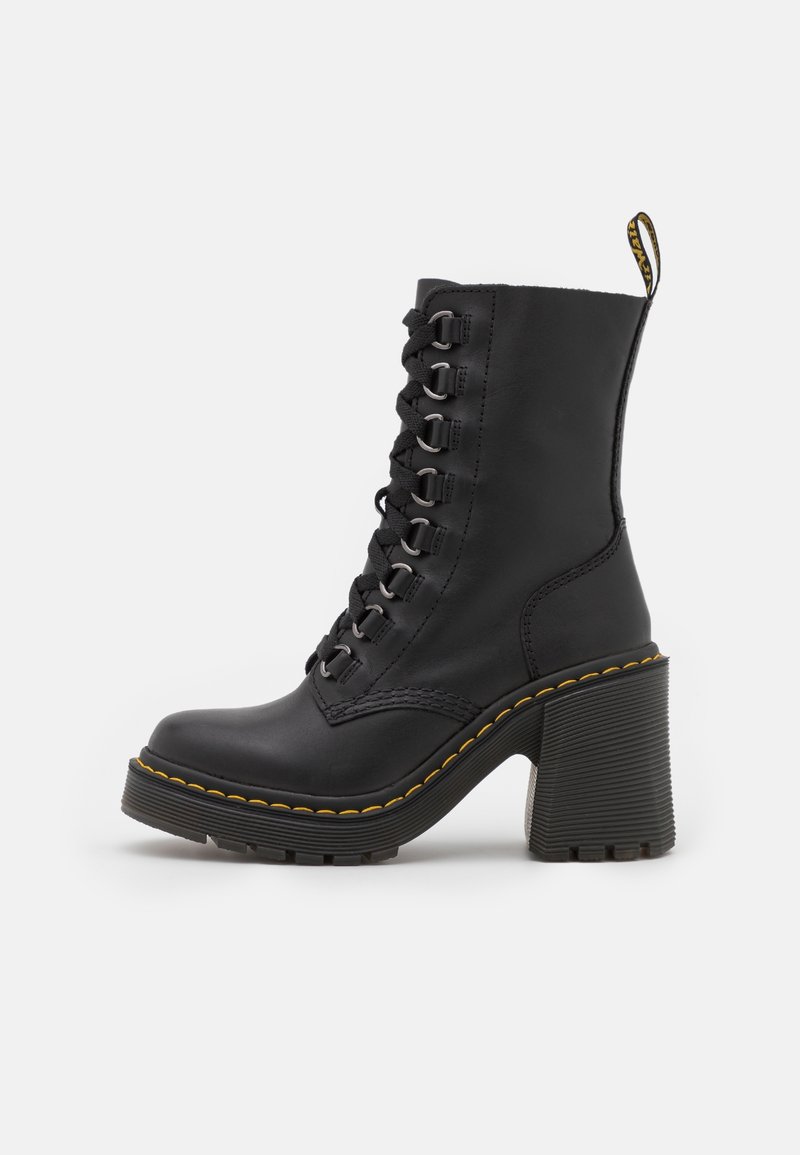 Black leather lace-up ankle boot with chunky high heel, yellow stitching around sole, and fabric pull tab at back on white background.