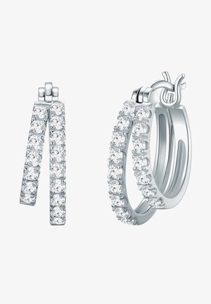 Strieborné kruhové náušnice s radom trblietavých čírych kryštálov pozdĺž vonkajšieho okraja, s hladkým oválnym tvarom a bezpečným zapínaním.