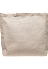 Beige Leinentragetasche mit weicher Textur, rechteckiger Form, zwei Stoffgriffen und leichtem Knicken. Schlichtes Design ohne Muster oder Akzente.