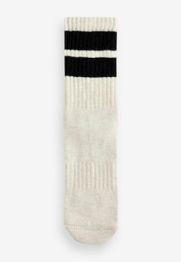 Knähöga krämfärgad strumpa med svart och vit randig ribbad topp. Slät textur med förstärkt tå och häl för extra hållbarhet.