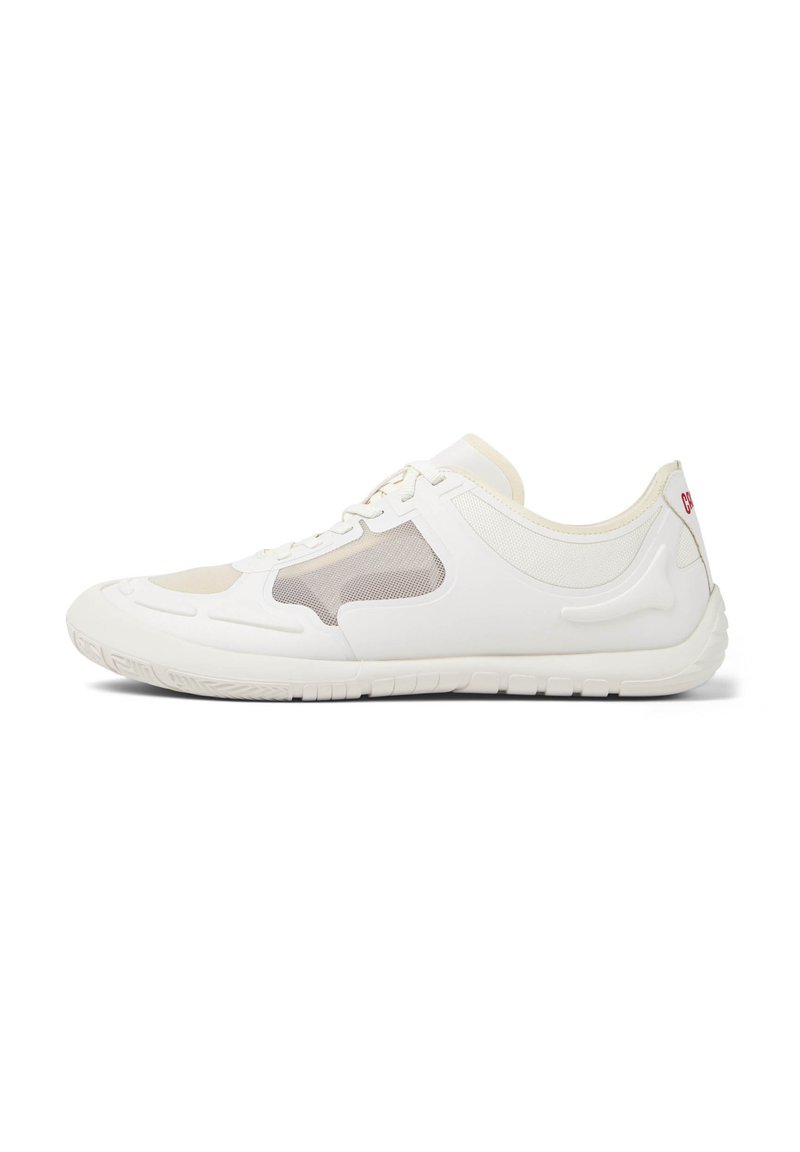 White athletic shoe with mesh panels, curved design, textured sole, and subtle beige accents. Features a lace-up closure and logo detail.