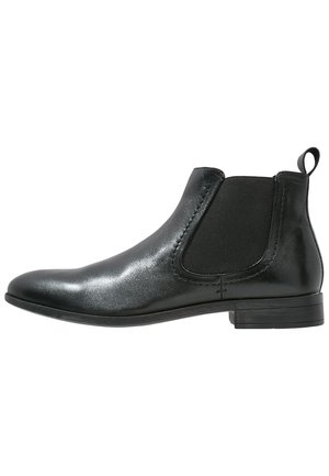 Schwarzlederne Knöchelstiefel mit elastischen Seitenwänden, abgerundeter Spitze und niedrigem Blockabsatz. Glatte Textur mit einem eleganten, glänzenden Finish.