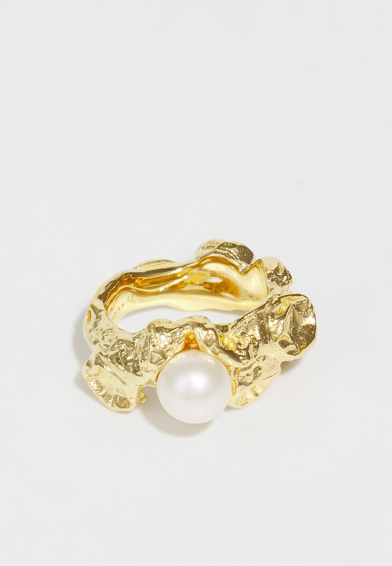 Gold ring with a textured, abstract design featuring a central white pearl. The band is uneven and sculptural, adding visual depth.