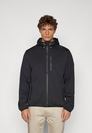 Chaqueta ligera negra con cremallera frontal, capucha ajustable y acentos en amarillo neón. Diseñada con un estilo minimalista y textura suave.