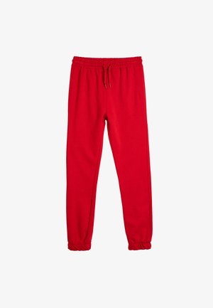 Pantalones jogger rojos con cintura y tobillos elásticos, con cordón, hechos de una tela suave, aislados sobre un fondo blanco.