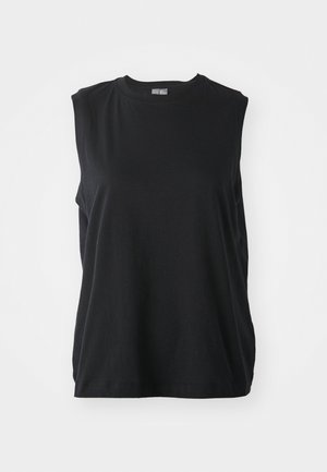 Top preto sem mangas feito de algodão macio. Apresenta um decote redondo e um corte solto, com fendas laterais para maior liberdade de movimento.