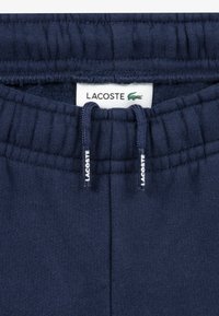 Lacoste CORE PANT UNISEX - Tracksuit bottoms - marine
