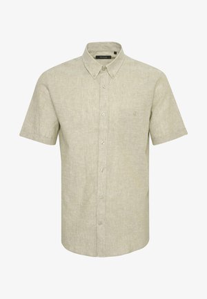 Beige, rövid ujjú, gombos ing, texturált anyagból, egyetlen mellzsebbel és keskeny gallérral. Az elején öt gomb található.