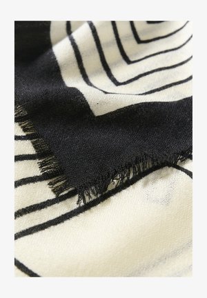 Crna i krem pletiva tkanina s geometrijskim oblicima, s isfrkanim rubom i mekim teksturom. Dizajn uključuje odvažne, linearne uzorke.