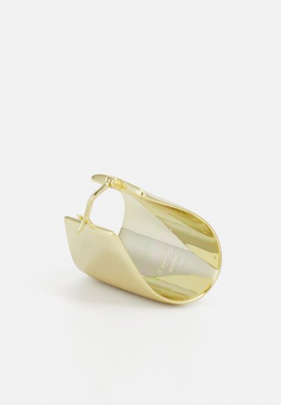 Gold-toned metal earring with a smooth, curved design, featuring a half-circle shape and an adjustable hinge for secure fastening.