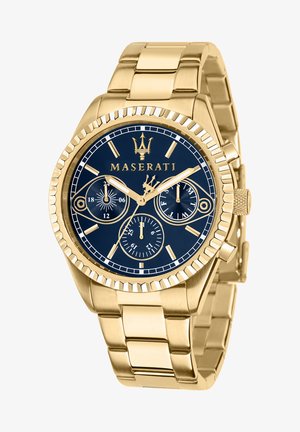 Gold-tone stainless steel watch with a navy blue dial, chronograph features, and a textured bezel. Links are smooth with polished finish.