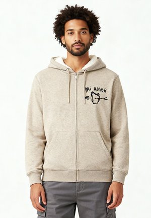 Gray zip-up hoodie with a fuzzy white lining, front pockets, and black embroidery reading "Mi Amor" with a heart and arrow design.
