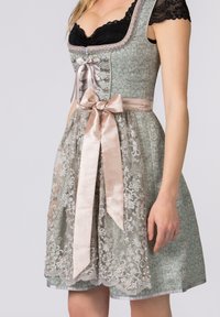 Green floral-patterned dress with lace overlay, satin bow at waist, and decorative buttons, featuring a sweetheart neckline and cap sleeves.