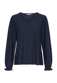 Blouse bleu marine à manches longues avec un col en V, tissu texturé présentant des motifs en losange, poignets froncés et finitions délicates aux coutures.