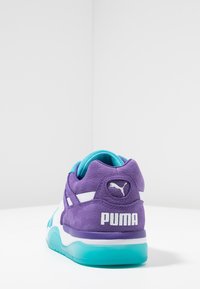 Purple suede sneaker with turquoise accents and white stripes. Features embossed logo on heel and cushioned sole for comfort.