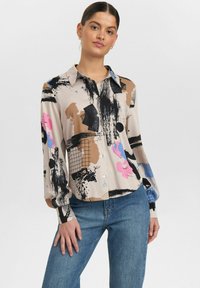 Langärmliges, knöpfbares Hemd aus beigem Stoff mit abstrakten Mustern in Schwarz, Pink und Blau, mit Kragen und Manschettendetails.