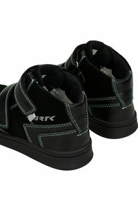 Czarne buty za kostkę z zielonym przeszyciem, paskiem na rzep i gumową podeszwą. Posiadają logo na pięcie oraz wyściełany kołnierz dla komfortu.