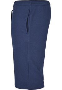 Donkerblauwe, knielange sweatshorts van een katoenmix. Voorzien van een elastische tailleband en zijzakken. Vlotte textuur, eenvoudig ontwerp.