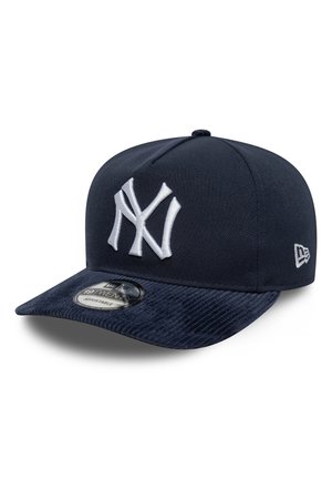 Casquette de baseball réglable New York Yankees bleu marine avec logo blanc brodé et visière plate texturée, vue de trois-quarts.