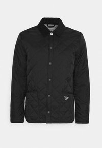 Veste matelassée noire avec motif en losange, col en velours côtelé, boutons-pression, poches latérales et branding brodé sur le bas devant.