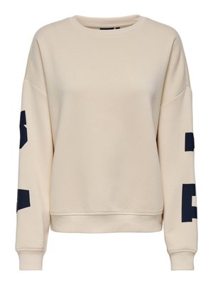 Beige crewneck sweatshirt with dropped shoulders and large black block letters printed on both sleeves.