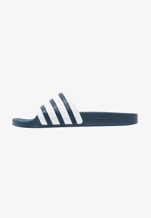 Sandale slide Adidas bleu marine et blanc avec trois bandes bleu marine sur la lanière blanche et logo Adidas sur le côté de la semelle.