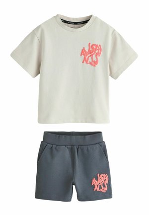Cream short-sleeve T-shirt and dark gray shorts set with pink "AllSaints London" text logos on chest and shorts leg.