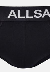 Black cotton brief with a black waistband featuring white knitted text reading "ALLSAINTS." Smooth texture and fitted design.