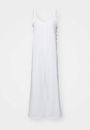 White linen jumpsuit with wide legs, camisole straps, and a straight neckline. Features a central seam and minimalistic design.