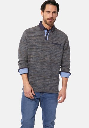 Long-sleeve polo shirt in a textured blue and gray knit, featuring a dark collar and button placket, with a chest pocket detail.