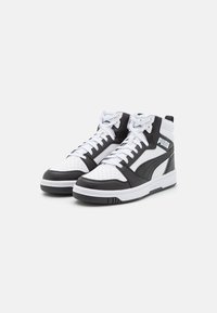 Hoge sneakers met een leren bovenkant, zwart-wit kleurenschema, geperforeerde neus, witte veters en logo detailing op de zijkant.